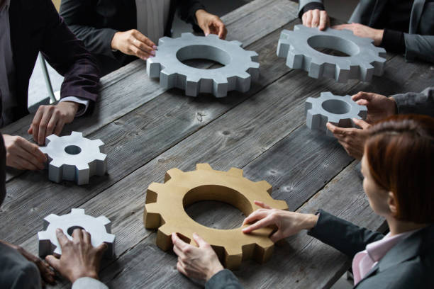 istock Business people joining together gears 1370512291