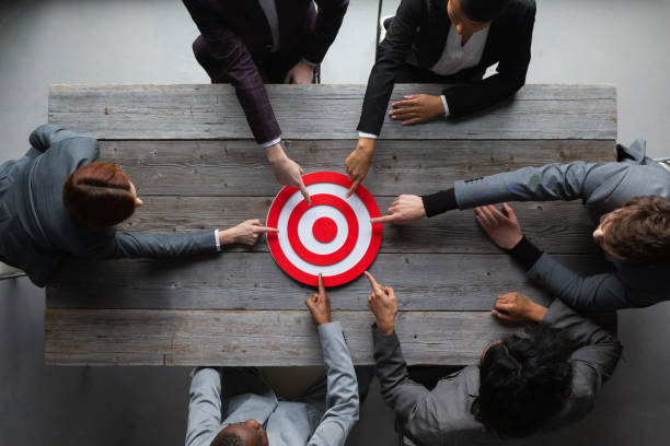 istock Business people pointing at red target 1370512297