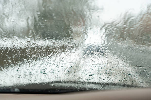 istock View through a car's front windshield covered in rain and melting snow 1370512936