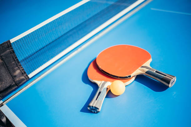 istock Two table tennis paddles next to the net. ping pong concept 1370514692