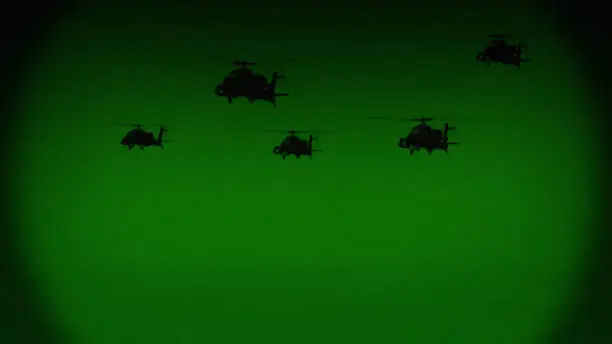 Apache AH-64 helicopters fly at night, night vision infrared.