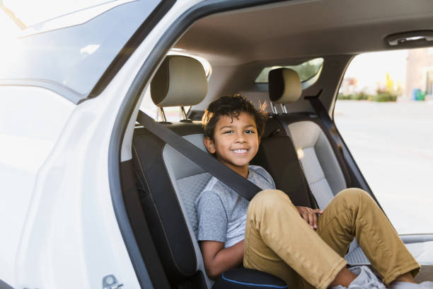 istock Elementary age boy, seated in car, smiles for camera 1370517278