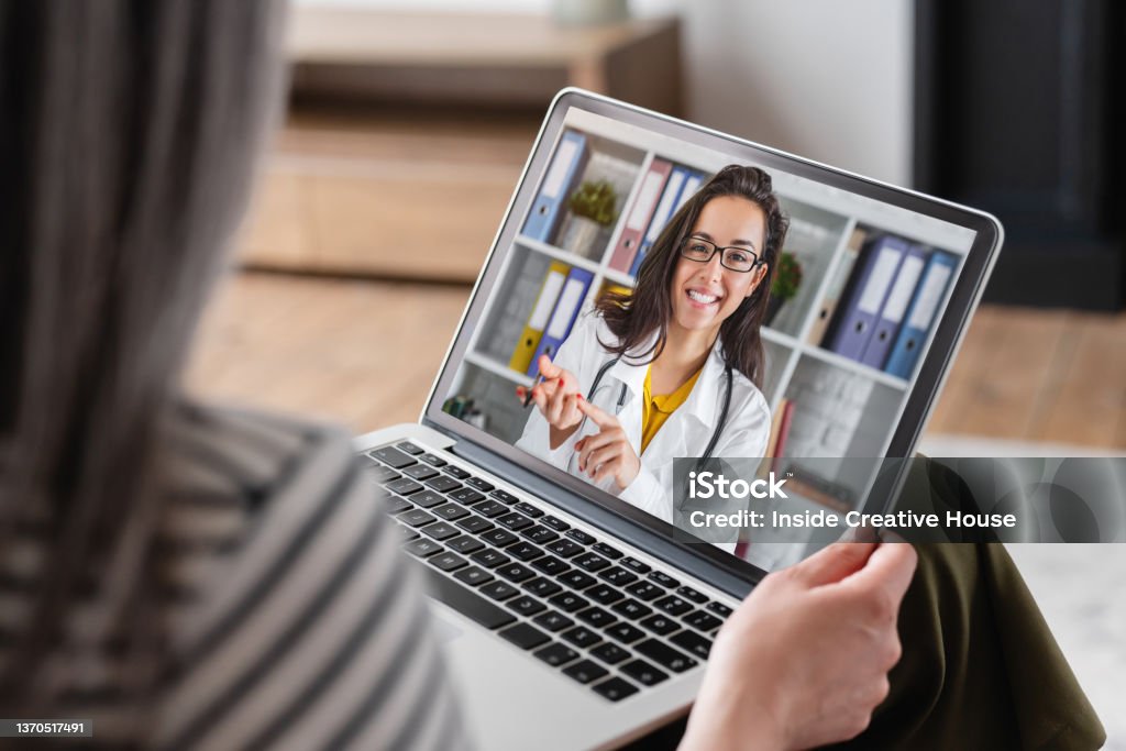 Senior old elderly pensioner woman grandmother having videocall conversation meeting virtual conference with a doctor telling about health problems on laptop remotely, telemedicine concept Telemedicine Stock Photo