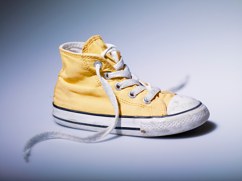 Yellow vintage sneakers isolated on a white