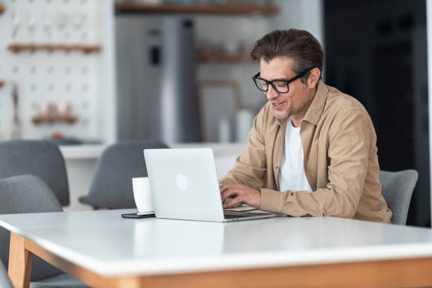 istock Happy entrepreneur working on a computer at home. 1370520841