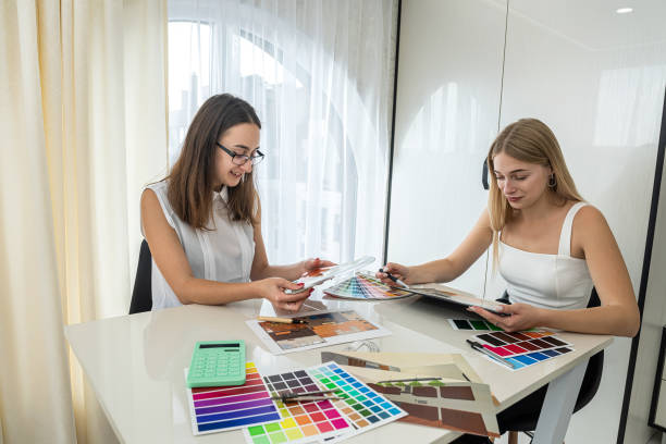 istock two designer discussing at perfect color for home, working with house plan 1370521157