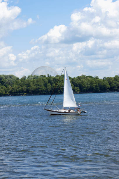 Montreal, Canada - July 26, 2008: sailboat on river Saint Lawrence in Montreal. In the background the Montreal Biosphere.