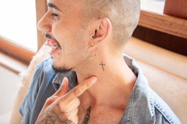 istock man in profile smiling and showing neck tattoo 1370522893