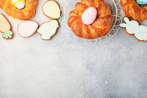 istock Spanish Easter cake. Traditional mona de pascua typical in Spain with boiled eggs eaten inside on light grey background. Typical food of the Spanish pastry Mona de Pascua. Top view. Mock up. 1370522971