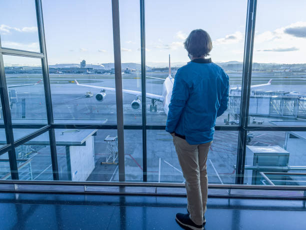 istock Man standing at airport terminal waiting 1370524046