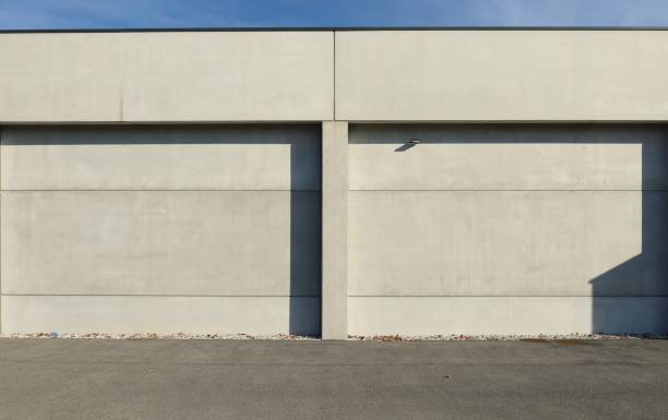 istock Concrete panel facade with a column in the middle. Aspalth road in front. 1370524160