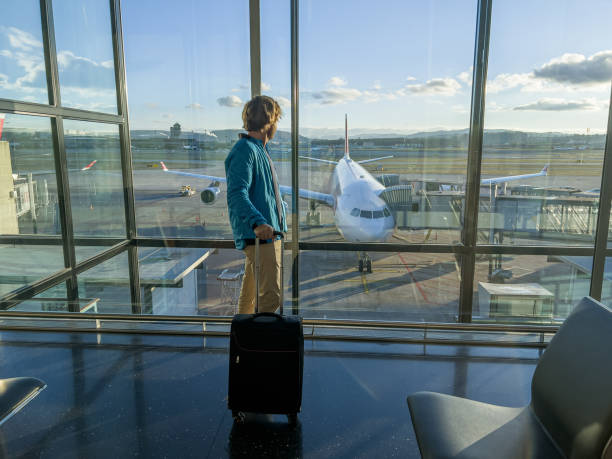 istock Man standing at airport terminal waiting 1370524290