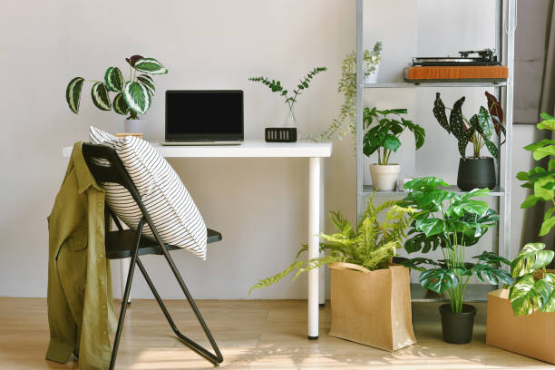 istock Home office decorate with green nature tree plants, Workspace and laptop computer on desk, Artificial houseplant for home and living room interior. 1370524343