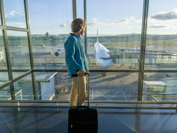 istock Man standing at airport terminal waiting 1370524422