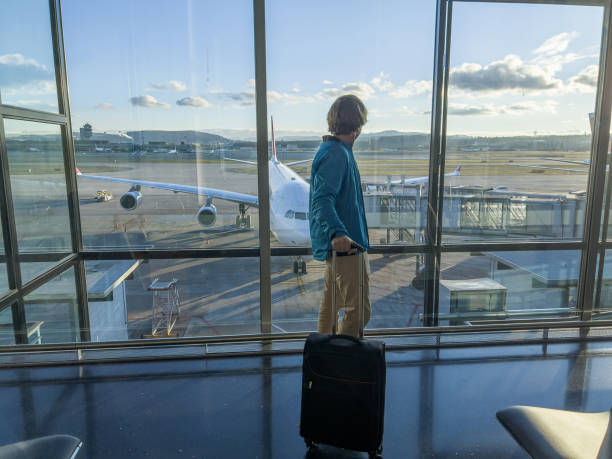 istock Man standing at airport terminal waiting 1370524437
