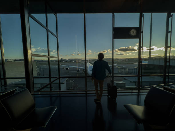 istock Man standing at airport terminal waiting to board flight 1370524805
