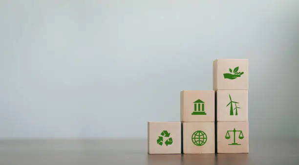 ESG Concepts on Environment, Society and Governance Revolving Sustainable Organization Development Wooden block with environmental ESG icon on gray background. copy space
