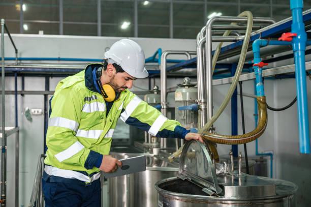 istock Caucasian technician engineer man in uniform with tablet checking and control boiler tanks and liquid pipeline in production line at factory 1370526448