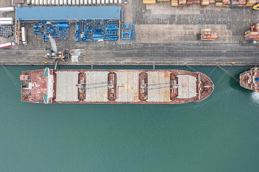 Top view of cargo ship in an international port.