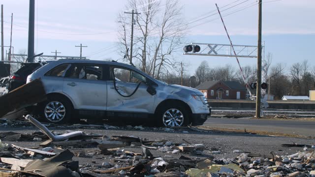 Road leaving Mayfield, KY and damaged car