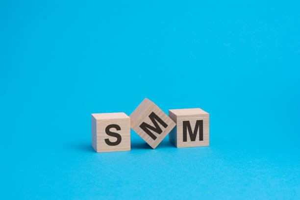 istock SMM text on wooden blocks, business concept, blue background 1370530040