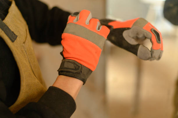 Close up of unrecognizable metal worker measuring iron with ruler.