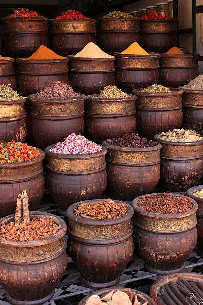 Photo of Various spices in large bows lined up in rows
