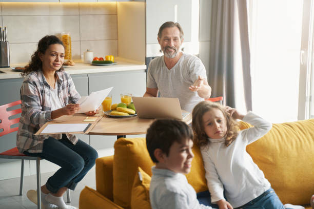 istock Caring father comforting upset girl on couch 1370533277