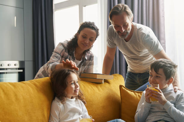 istock Mother touching daughter head near husband and son 1370534150