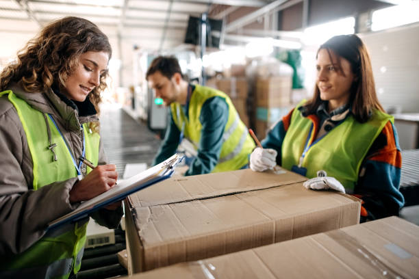 istock Male and female workers at distribution center 1370535016