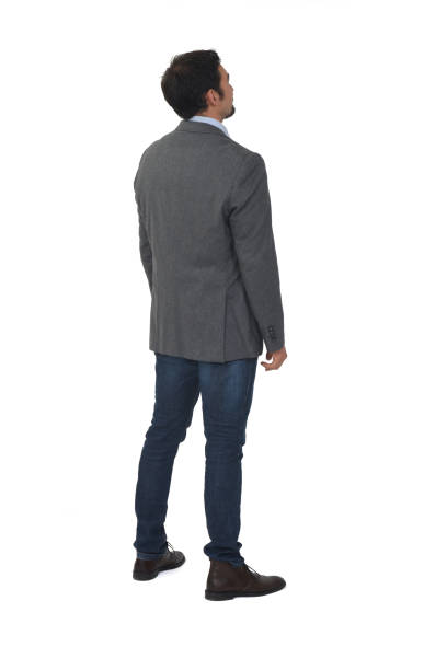 man isolated on white background rear view of a man with blazer and jeans looking up on white background man standing profile stock pictures, royalty-free photos & images