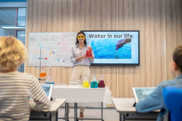 istock Woman in goggles with flask looking at class 1370537132
