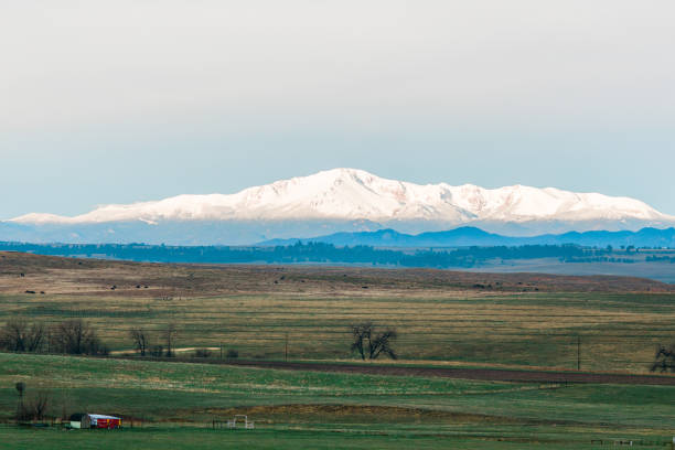 istock Snowy Mountain Peak with Green Farmland 1370538693