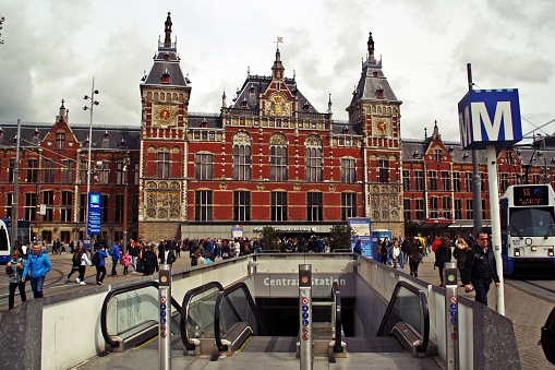 Amsterdam, Holland; 04 30 2016. It is the main train station in the real heart of the city and the entrance to the underground (metro).