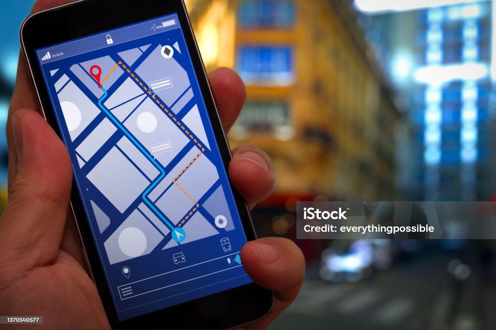 Close up of Tourist using GPS map navigation on smartphone application screen for direction to destination address in the city with travel and technology concept. Pursuit - Concept Stock Photo