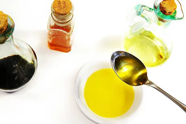 table spoon of olive oil with various ingredients