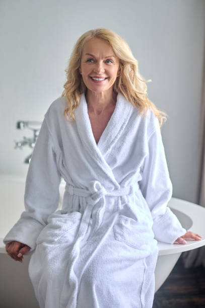 istock A blonde middle aged woman in a white robe 1370544976
