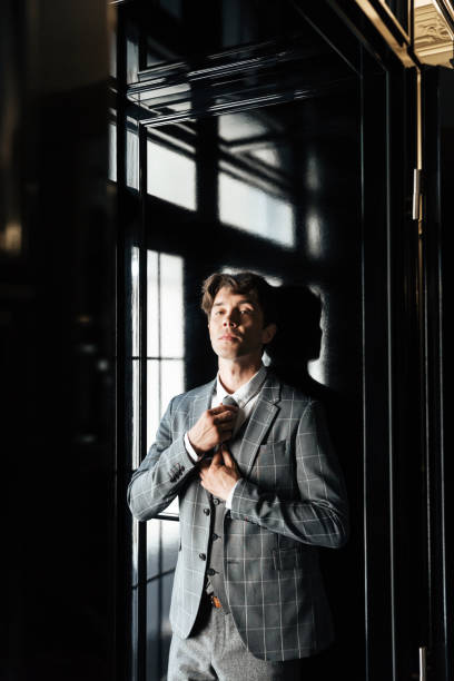 istock Handsome successful business man in suit and tie posing 1370545334