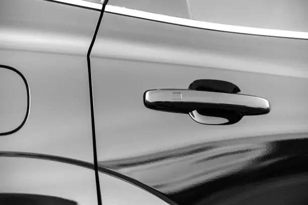Black car door handle close up. photo of the door of a modern car with focus on the door handle.