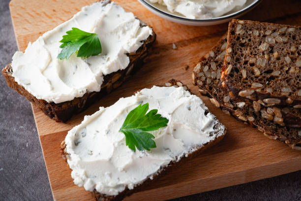 istock Rye bread with cream cheese on grey table. Whole grain rye bread with seeds 1370545464