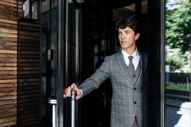 Mid adult businessman walking and meeting coworker in the city