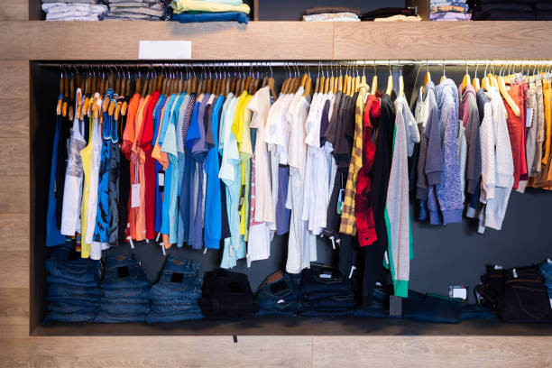 istock Men casual clothes on hangers and shelves 1370545624