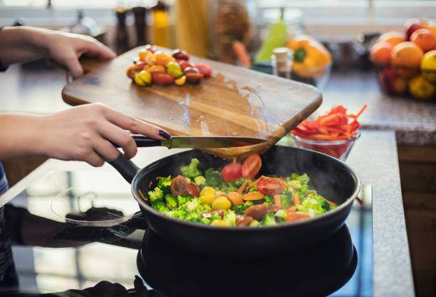 istock Woman steaming mixed vegetables in the kitchen 1370545712