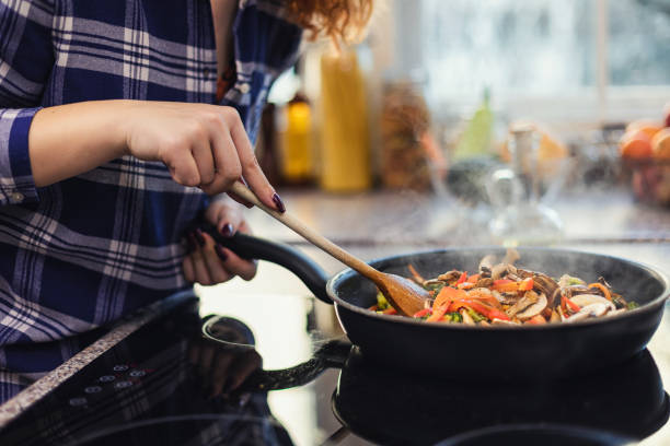 istock Woman steaming mixed vegetables in the kitchen 1370546244
