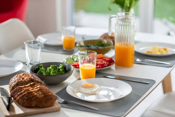 istock Breakfast closeup with eggs, wholegrain bread, fresh broccoli, and orange juice 1370548304