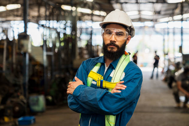 istock Engineers and skilled technicians are maintaining machinery. Engineers are working and repairing machines in industrial. worker smiling while standing with arms crossed near factory. 1370548904