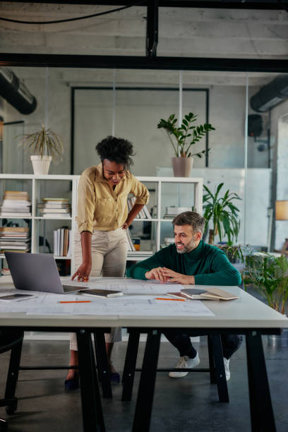 istock Diverse business couple having a discussion in an office 1370549263