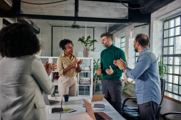 istock Happy businesspeople applauding good presentation in office 1370549264