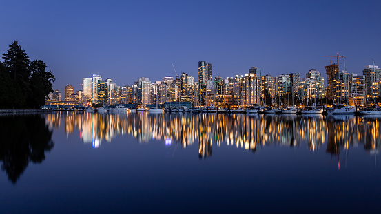 Panoramic view of Downtown Vancouver cityscape during sunset from Stanley Park sea wall, Vancouver, British Columbia, Canada