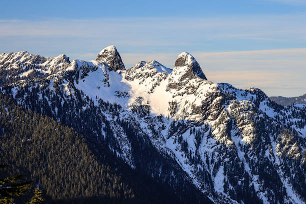 The Lions peaks during winter, North Shore Mountains, Vancouver, British Columbia, Canada. The Lions peaks during winter, North Shore Mountains, Vancouver, British Columbia, Canada. north shore stock pictures, royalty-free photos & images